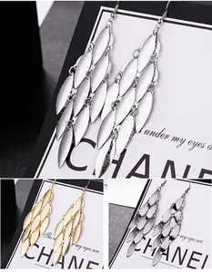 Detailed view of fashionable long metallic leaf tassel earrings in various colors
