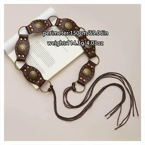 Close-up of Bohemian waist belt with brass studs and tassels showing 150cm perimeter