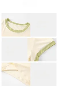 Close-up details of contrast collar, cuffs and hem stitching on a cream yoga T-shirt.