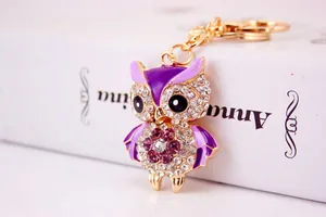 Close-up of a cute rhinestone owl keychain with purple enamel and sparkling crystal details