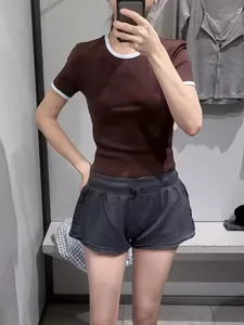 Slim fit brown t-shirt with white contrast ringer neck and cuffs shown in mirror selfie