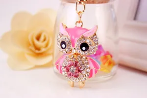 Detailed macro view of a pink rhinestone-encrusted owl keychain with gold-tone finish.