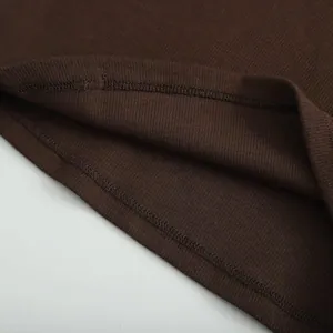 Close-up of ribbed texture and neat stitching on a dark brown slim-fit T-shirt.
