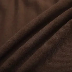 Close-up detail of soft brown ribbed fabric texture for minimalist slim fit T-shirt.