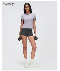 Close-up of women's lavender sport T-shirt with contrast trim and grey yoga shorts