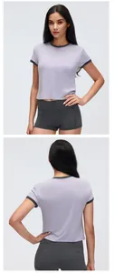 Front and back view of lavender cropped athletic t-shirt with grey trim for women