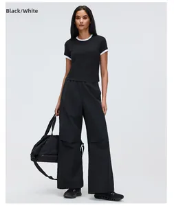 Female model in black contrast ringer sports t-shirt and wide-leg yoga pants