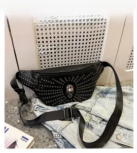 Detail view of black punk style fanny pack featuring silver studs and a crystal skull