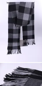 Detailed view of a men's black and gray checkered winter scarf with soft fringe edges.