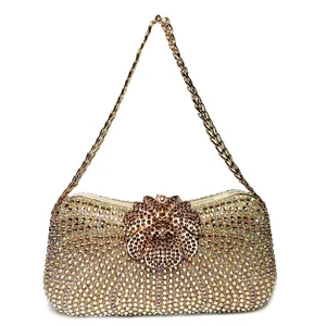 Close-up of luxury gold rhinestone clutch bag with a sparkling jewelry floral clasp