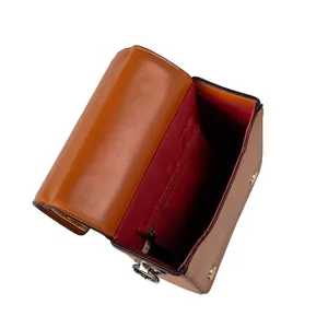 Internal view of a vintage brown crossbody bag with red lining and zipper pocket