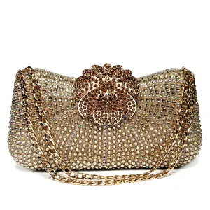 Close-up detail of luxurious gold crystal evening clutch bag with flower clasp
