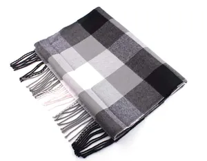 Macro detail view of a soft grey and black checkered plaid scarf with fringe accents