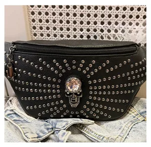 Punk style black leather fanny pack featuring a silver skull and decorative metal rivets