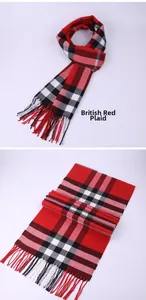 Detailed view of a classic British style red plaid winter scarf with fringe accents
