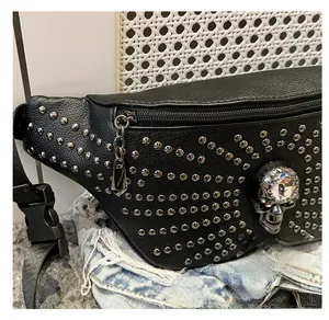 Close-up detail of punk style waist bag with metallic skull and studs