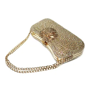 Detailed view of an elegant gold evening clutch bag covered in sparkling rhinestones