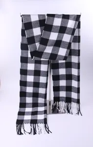 Classic black and white checkered scarf with tassel detail displayed on a stand.