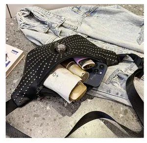 Detail view of stylish punk chest bag featuring silver rivets and a decorative skull metal clasp