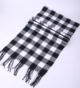 Close-up of a classic black and white checkered scarf featuring soft tassel fringe details