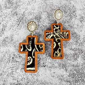 Detailed view of western style wooden cross earrings with patterned leather inlay for Easter