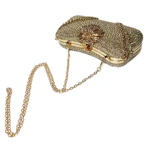 Detailed macro view of luxury sparkling rhinestone evening clutch with gold flower clasp