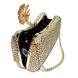 Detail view of sparkly gold rhinestone evening clutch bag with chain strap