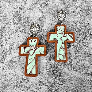 Detailed view of Western-style wooden cross earrings with textured leather inlay
