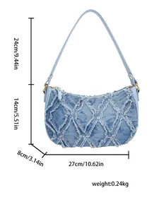 Detailed view of a blue denim crescent bag with frayed diamond patterns and dimensions.