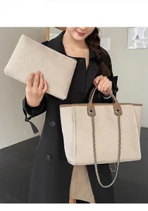 Large beige textured fabric tote bag and matching clutch set with elegant chain strap