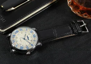 Close-up of men's automatic mechanical watch with blue Roman numerals and black leather strap