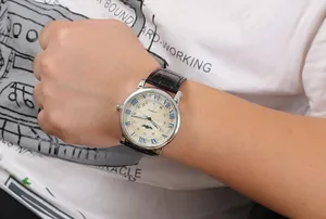 Close-up of Winner men's automatic mechanical watch with Roman numerals and leather strap