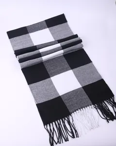 Close-up view of black and white buffalo plaid scarf with soft fringe tassels