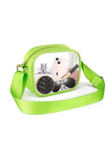 Neon green transparent PVC crossbody bag with wide removable strap showing essentials inside
