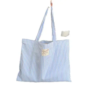 Blue and white striped canvas tote bag with large capacity for daily commuting.