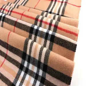 Detailed view of a classic British plaid pattern on a soft autumn winter scarf texture