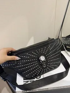 Punk style black fanny pack with silver studs and skull detail