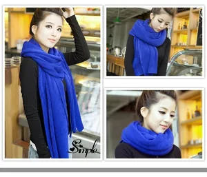 Detailed shots of a bright blue winter knitted scarf shown in various styles on a model