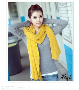 Stylish long yellow knit scarf providing warmth and elegance for autumn and winter