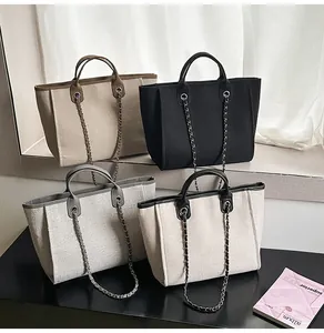 Group display of large capacity canvas tote bags with chain straps in four colors