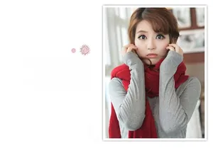 Close-up of a stylish solid red knitted scarf worn by a model in winter outfit