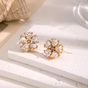 Close-up of elegant flower-shaped stud earrings with sparkling heart-cut crystals
