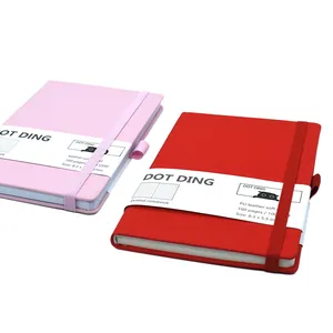 Detail of red and pink dotted notebooks with PU leather soft covers and elastic straps