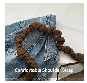 Close-up of the comfortable brown ruched shoulder strap on a quilted chest bag