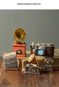 Vintage resin miniatures of gramophone and camera displayed on old books.