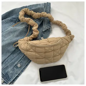 Detail view of khaki quilted chest bag with smartphone for size reference