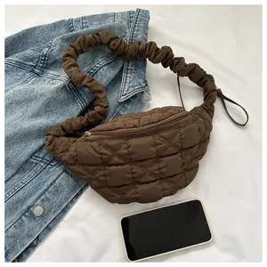 Fashionable brown quilted chest bag with a unique gathered scrunchie strap design.