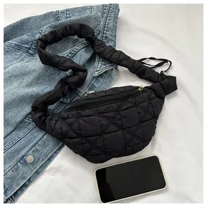 Close-up of black quilted chest bag with a stylish oversized scrunchie strap detail.