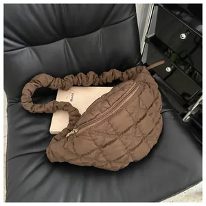 Close-up of a brown quilted crescent chest bag featuring a unique scrunchie strap