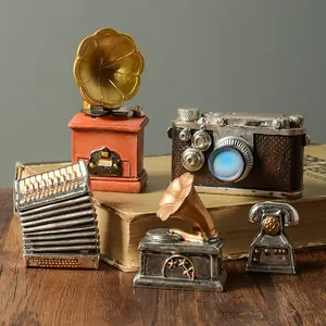 Set of vintage resin ornaments featuring a miniature gramophone and camera for decor